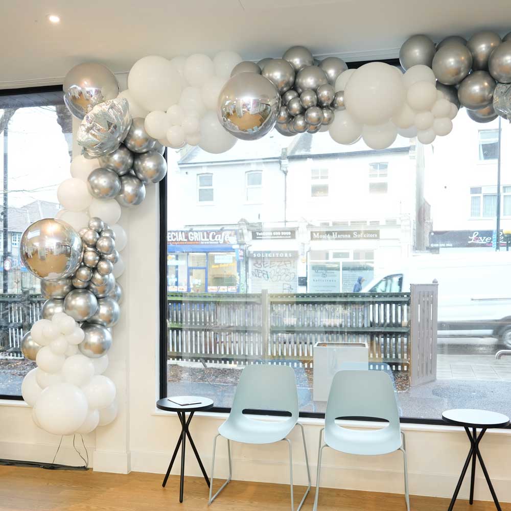 Balloon decoration setup around windows.