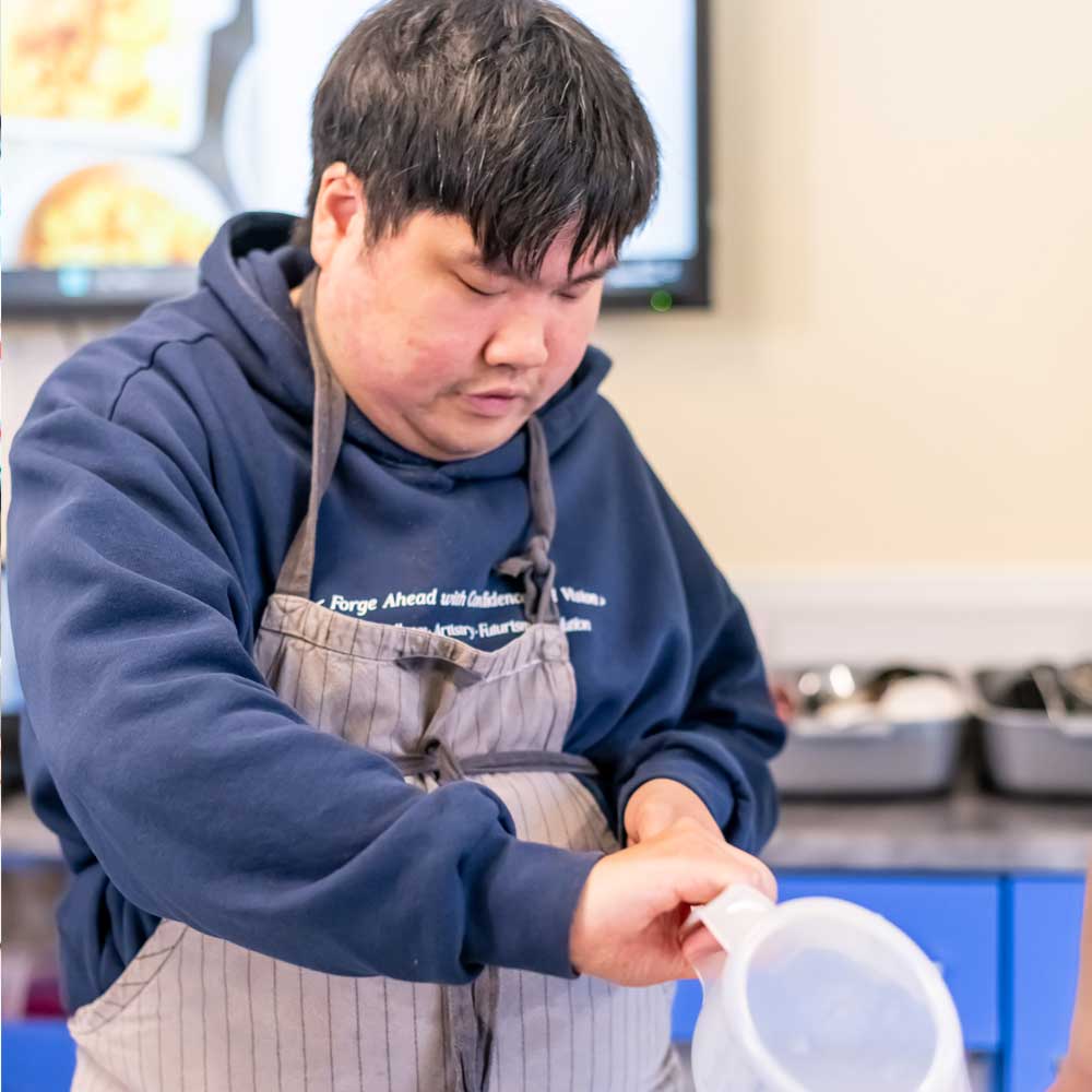 A learner holding a jug during a life skills lesson.