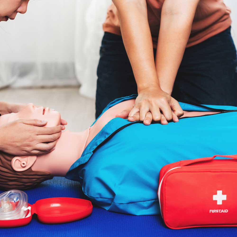 Learners practising CPR on a dummy.