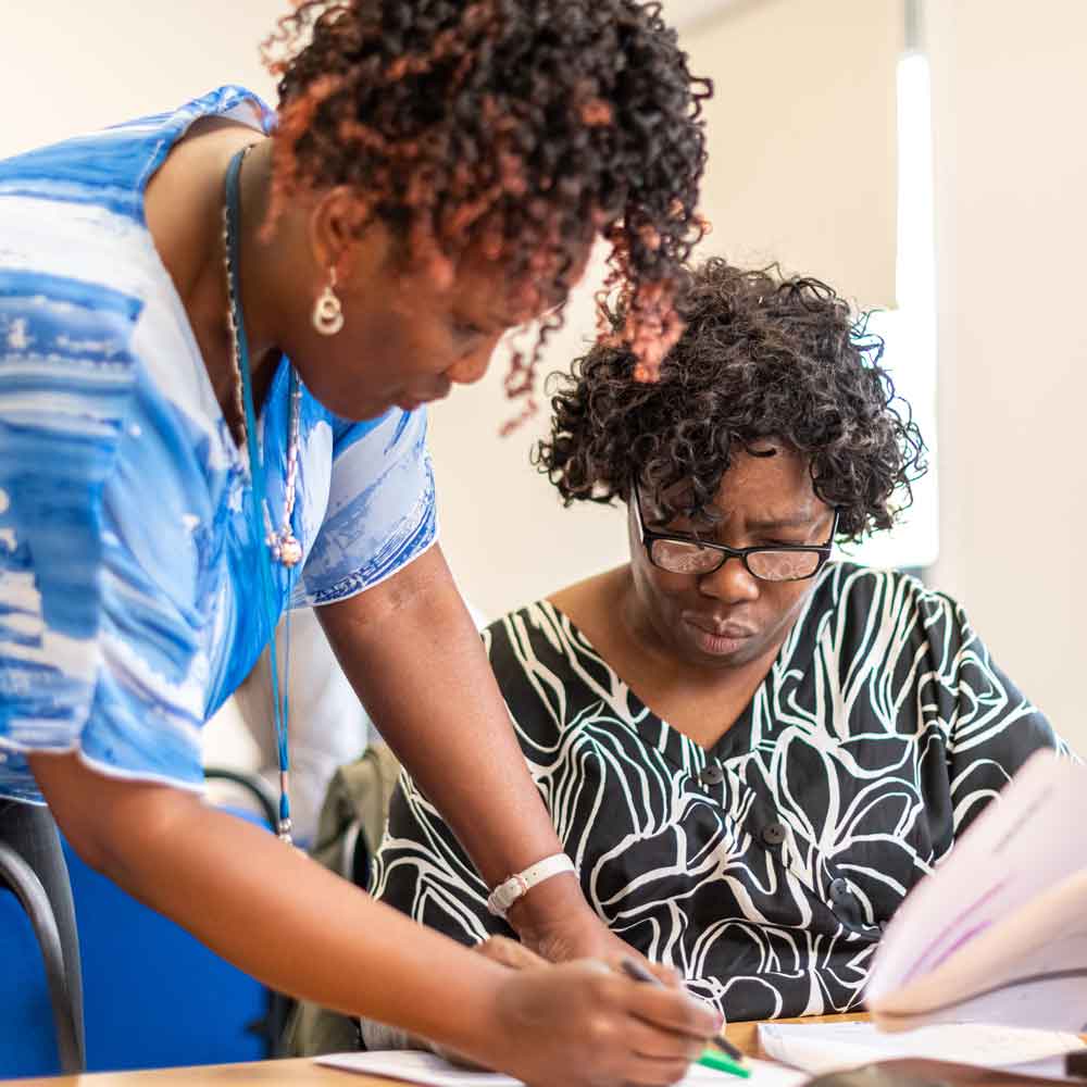 Tutor helping student in a maths class