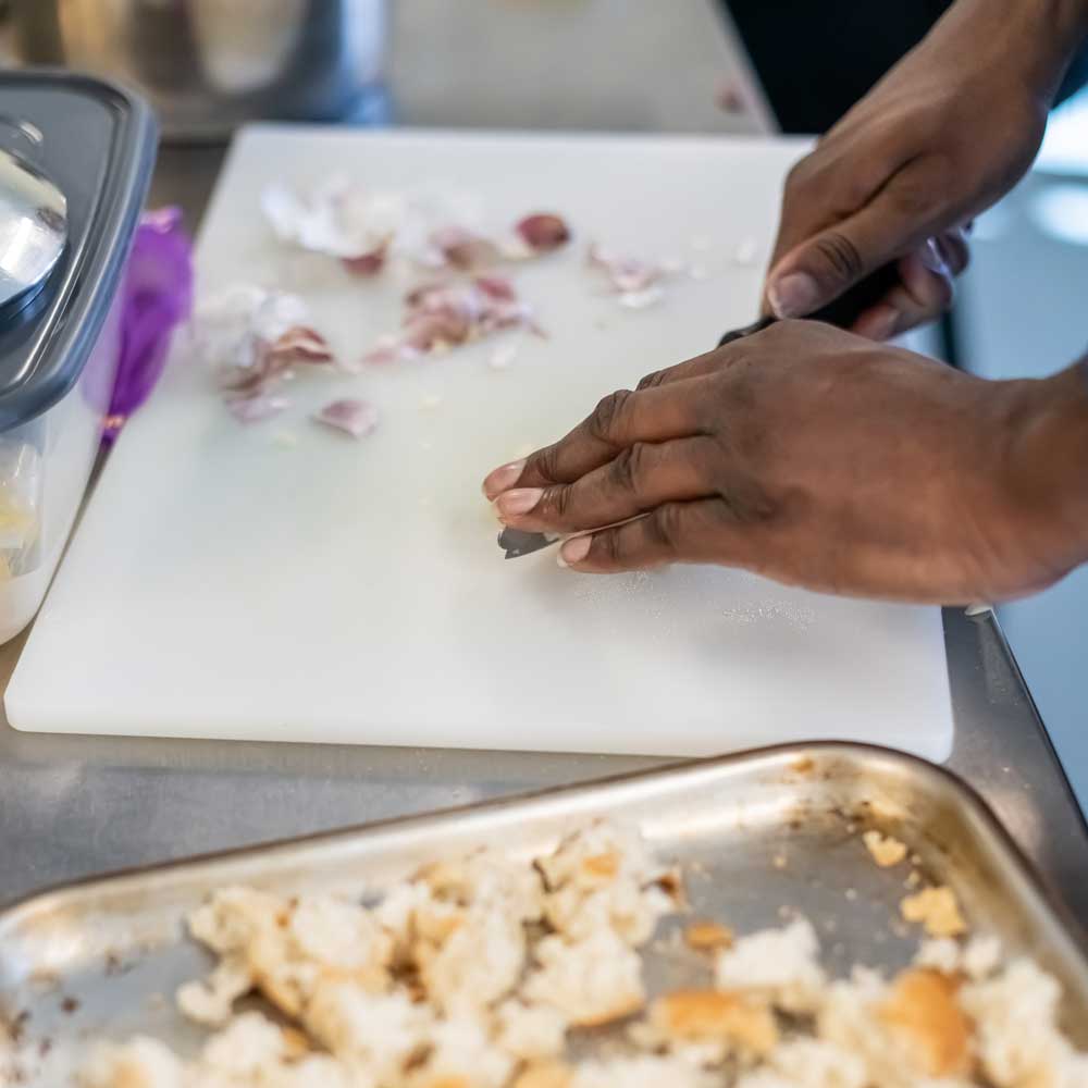 Learner preparing food during a life skills cookery session.