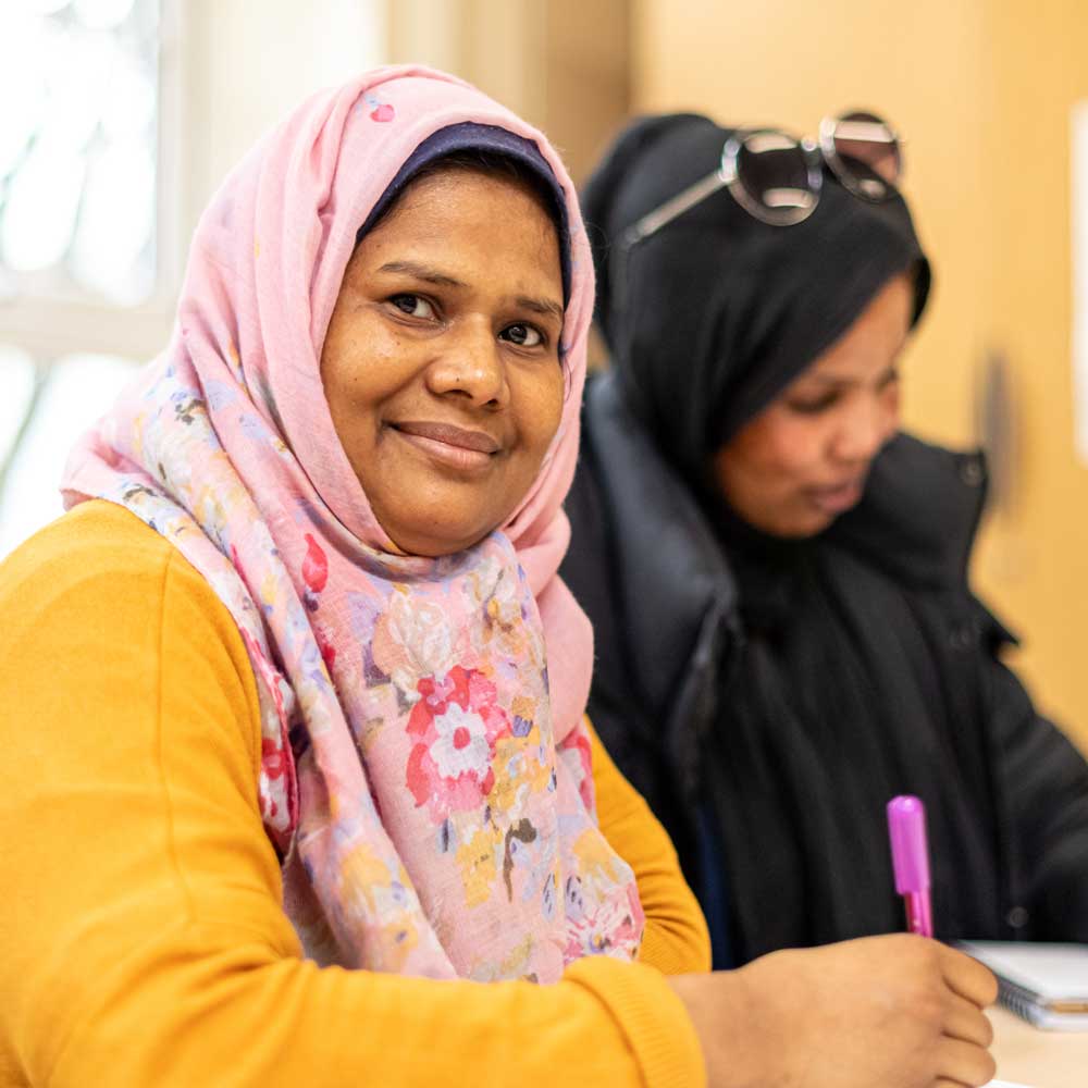 Two learners sitting at a desk.