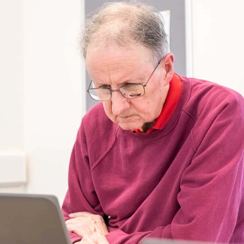 Learner studying at a laptop.