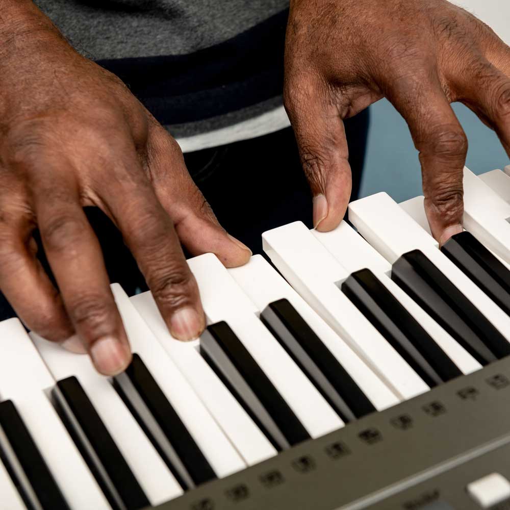 Hands playing a keyboard.