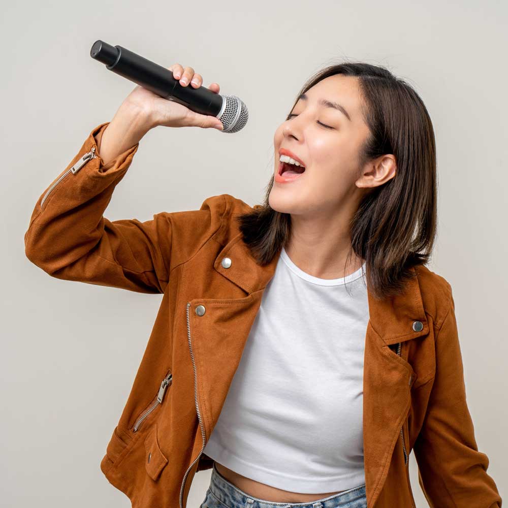 Learner singing with a microphone.